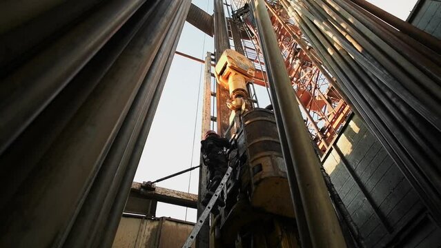 Top Drive System TDS and Derrick of Oil Drilling Rig