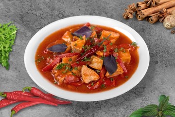 Spicy red chicken soup. Chicken vindaloo. Butter chicken Murgh Makhani curry Indian spices hot and spicy gravy dish.