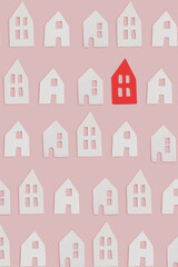 Fototapeta na wymiar White and one red small decor ceramic houses with windows on pink flat lay background. Minimal creative card or wallpaper idea. Top view pattern. Stand out concept.