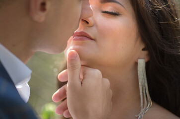 portrait of a man in a suit and a woman in a white dress close-up, the concept of a kiss..