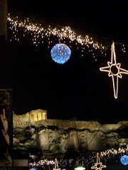 Christimas lights in front of the Parthenon in the Acropolis of Athens, Greece at night