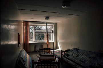 Empty room in an abandoned building. Soviet architecture. Light in the window. Beautiful shadows. Atmospheric photo of an abandoned building.