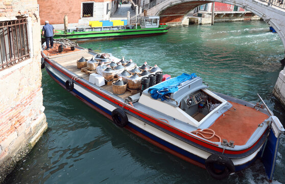 boat for the transport of wine demijohns in the navigable canal in Venice in Italy in Europe