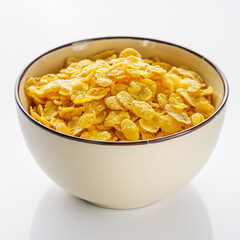 crispy golden cornflakes on a white acrylic background