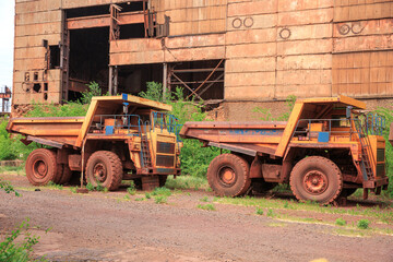 Decommissioned quarry trucks awaiting disposal. Iron ore mining equipment at the end of its useful...