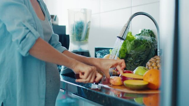 Pregnant diet. Pregnant woman prepares healthy food on the modern kitchen