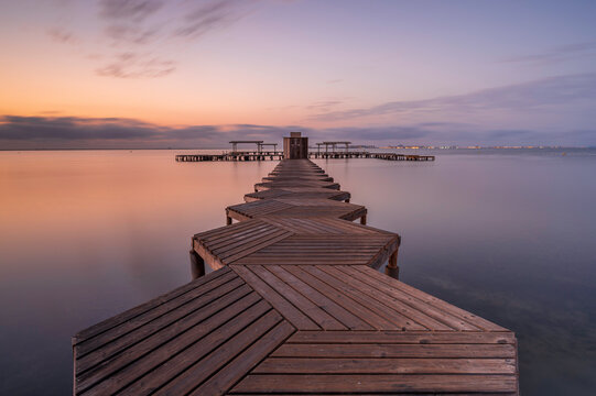 Wooden Jetty, reaching into the Mar Menor, in southern Spain, at sunrise. Long exposure to smooth out the sea