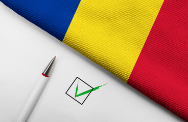 Pencil, Flag of Romania and check mark on paper sheet
