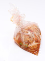 Papaya salad in a bag placed on a white background