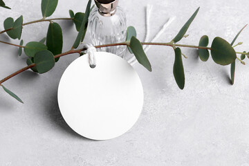Round white gift tag mockup with eucalyptus leaves on grey background, label tag mockup, Wedding...