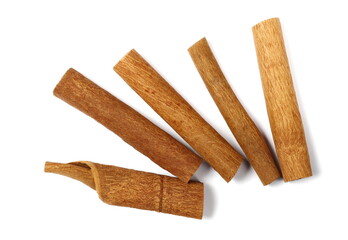 Cinnamon sticks pile isolated on white, top view