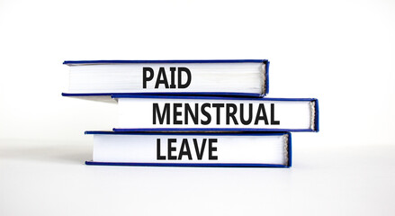 Paid menstrual leave symbol. Concept words Paid menstrual leave on books. Beautiful white table white background. Business medical paid menstrual leave concept. Copy space.