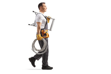 Electrician walking and carrying cables and ladder