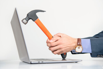 hammer in hand hitting the laptop, closeup