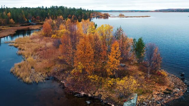 Aerial view of the lake in Kola Peninsula in Russia. Flight over the lake in arctic area during autumn