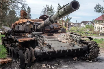 Rolgordijnen Russian tank destroyed by the Ukrainian army in the Kyiv region. Selective focus. © vladk213