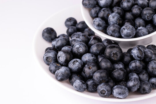 Blueberry in white bowl and plate on white background.close up image