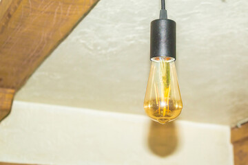 Modern long light bulb. The light bulb is glowing. Work light