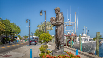 Tarpon Springs sponge docks with boats and diver statue in this greek inspired small town in Florida