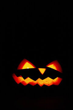 Happy Halloween pumpkin with light at the night. Dark Halloween wallpaper