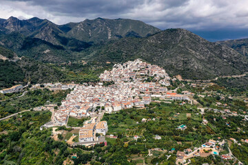 Fototapeta na wymiar Aerial perspective of Ojen village, small white Andalusian town located in the mountains, in the heart of the Costa del Sol, not far from Marbella. In background beautiful mountains of Sierra Blanca 
