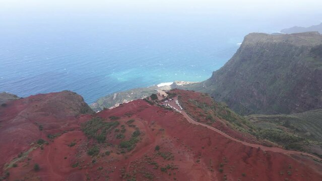 Aerial view of stunning viewpoint Mirador de Abrante with glass observation balcony above Agulo village in La Gomera island. Restaurant on red clay
