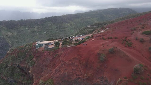 Aerial view of stunning viewpoint Mirador de Abrante with glass observation balcony above Agulo village in La Gomera island. Restaurant on red clay