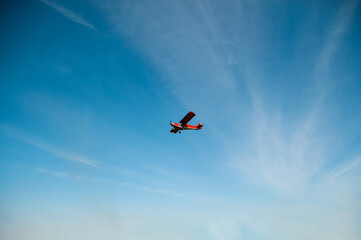 Fototapeta na wymiar Red plane against the sky.