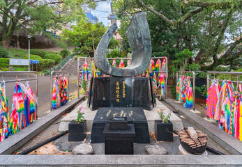 nagasaki, kyushu - december 11 2021: Atomic bomb memorial monument shaped as the flame of memory created in 1973 in the Nagasaki Peace Park by the association of Japan Telecommunications worker. - obrazy, fototapety, plakaty