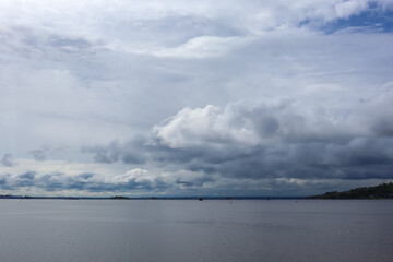 beautiful water landscape. a bunch of gray blue clouds. ships in the distance