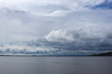 Obraz premium beautiful water landscape. a bunch of gray blue clouds. ships in the distance