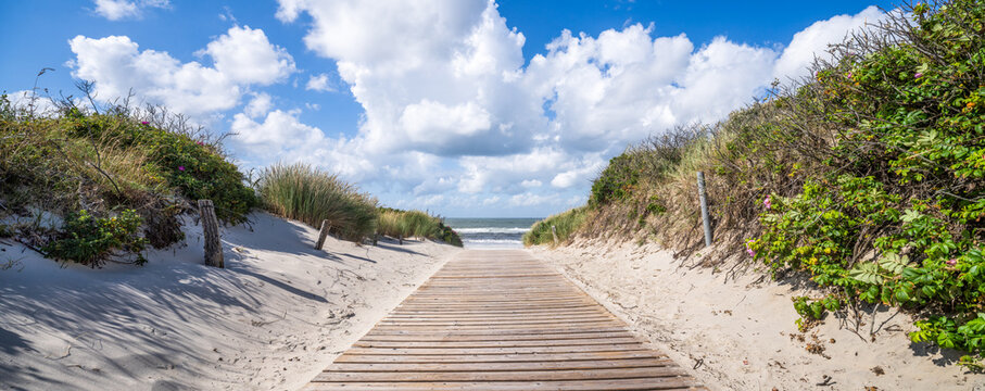 Wooden boardwalk to the dune beach