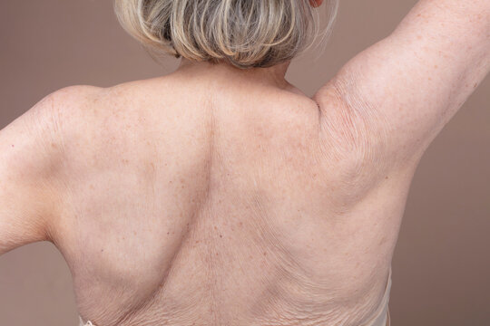 Rear view of shirtless senior woman