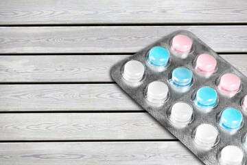 White blister tablets on pastel background