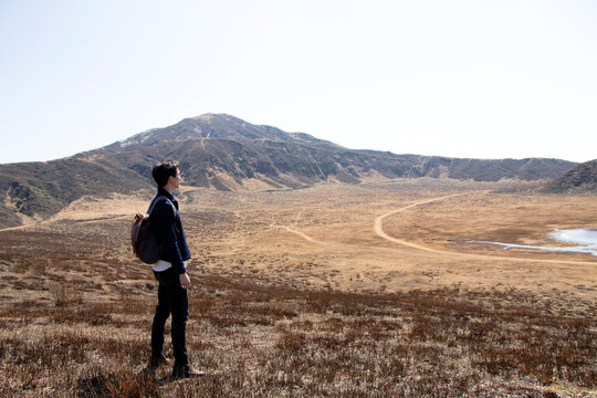 Japan, Kumamoto, Hiker looking at landscape
