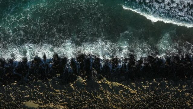 Tropical stony beach with caribbean sea waves. Travel destination. Aerial top view