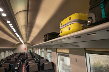 Suitcases lying in the cabin of the train in places for the handle luggage. Travelling in Europe by...