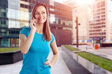 Fototapeta premium Woman tourist walking relaxed in center of city with phone. Lifestyle, female beauty concept