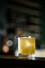 Fruit mixology with mezcal and dry lime on black marble background. Warm colored cocktails. Mezcal cocktail.