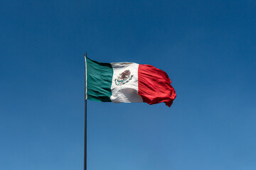 Mexico national offcial flag on clean and clear blue sky background