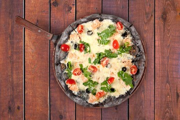 Traditional pizza with cheese and meat on wood desk. Pizza with four cheese combination. Cheese pizza.