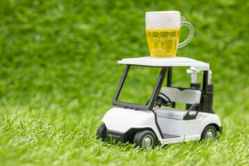Golf cart with beer on green grass