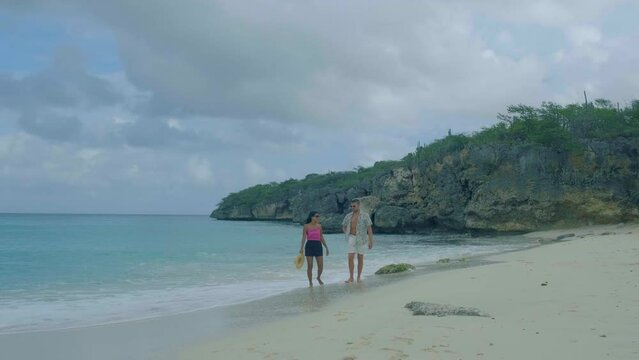  Cas Abou Beach Curacao on the caribbean island of Curacao, Playa Cas Abou in Curacao Caribbean tropical white beach with blue ocean men and woman on the beach, couple mid age on vacation
