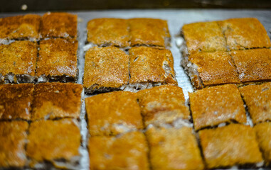 The snack is called Babin. It is an ancient Thai dessert made from coconut flour and sugar, fried in a pan.
