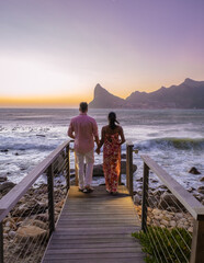 Fototapeta premium couple man and women drinking coffee during on balcony sunrise at vacation in Cape Town South Africa. 
