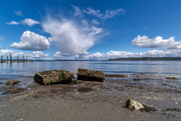 Fluffy white clouds fill the sky above Puget Sound in Tacoma, Washington.