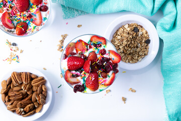 nutritious yogurt with cereal, strawberries, sweet sprinkles, blueberries