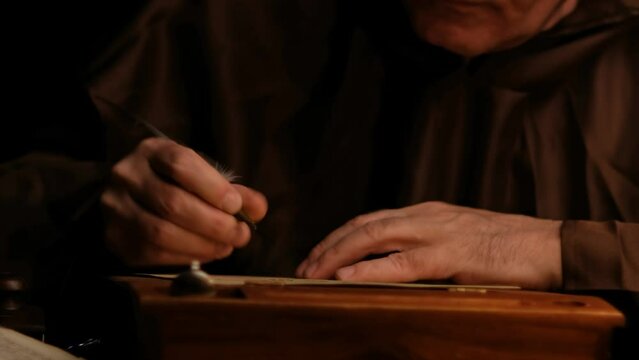 Video of ld monk takes a manuscript out of the document box, signs it, wet paperweight, and puts it back.