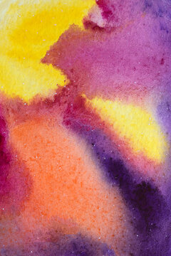 Bright red, purple and yellow colours mixed spots and streaks. Aquarelle gradient on paper background.