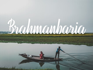 Brahmanbaria / Bangladesh - April ‎09 ‎2021: Man rowing boat with bamboo.